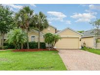 Charming single-story home featuring a well-manicured lawn and mature palm trees at 3896 Esplanade Ave, Port Orange, FL 32129