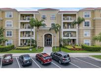 Inviting condo exterior with a well-maintained facade, lush landscaping, and convenient parking spaces at 4804 Cayview Ave # 20512, Orlando, FL 32819