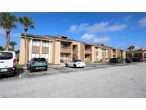 Attractive condo building featuring parking, landscaping, and direct access to various units at 5027 Vineland Rd # 5027, Orlando, FL 32811