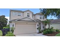 Charming two-story home with a well-manicured lawn, attached garage, and neutral exterior paint at 844 Suffolk Pl, Davenport, FL 33896