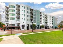 Multi-story condominium building featuring an attractive color scheme, well-maintained landscaping, and convenient commercial space at 10 N Summerlin Ave # 14, Orlando, FL 32801
