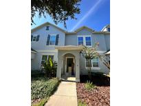 Charming townhome with a covered entryway and well-maintained landscaping in a desirable neighborhood at 12359 Langstaff Dr, Windermere, FL 34786