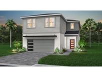 Charming two-story home with a gray exterior, a two-car garage, and well-manicured landscaping at 15971 Sandy Cliffs Dr, Clermont, FL 34714