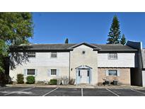Two-story townhome boasts brick accents, pale blue trim, and mature trees at 3057 Aaron Burr Ave # 1, Winter Park, FL 32792