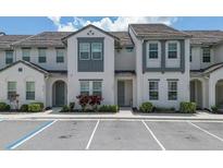 Charming two-story townhome features neutral paint, tile roof, and well-maintained landscaping at 306 Captiva Dr, Davenport, FL 33896