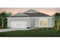 Charming single-story home with a two-car garage and neutral-colored facade and well-manicured lawn at 3095 Norcott Dr, Davenport, FL 33837