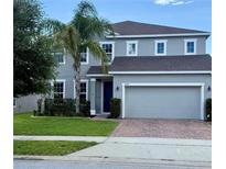 Charming two-story home with a well-manicured lawn, lush landscaping, and a spacious two-car garage at 3472 Gretchen Dr, Ocoee, FL 34761
