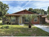 Charming single-story home featuring stone accents, a palm tree, and a well-maintained front yard at 3700 Washington St, Sanford, FL 32771