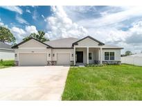 Beautiful single-Gathering home with a three car garage and well-manicured lawn at 5908 Sw 115 Street Rd, Ocala, FL 34476