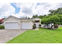 Charming single-story home with a manicured lawn and a two-car garage, offering curb appeal at 604 Timberwilde Ct, Winter Springs, FL 32708