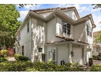 Corner view of a two-story home showing the architectural details and manicured landscaping at 6874 Slaven Dr, Orlando, FL 32819