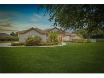Spacious front yard showcases a single story home with stone accents and beautiful landscaping at 748 Mills Estate Pl, Chuluota, FL 32766