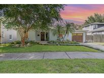 Charming home with lush landscaping, manicured lawn, and a quaint facade at 1219 Oakley St, Orlando, FL 32806