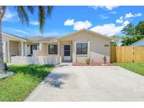 Charming single-story home with a well-manicured lawn and welcoming front entrance with beige concrete driveway at 1920 Dardanelle Dr, Orlando, FL 32808