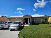 Charming single-story home featuring a well-manicured lawn and a screened front entrance, with parking for two cars at 306 Aylesbury Ct, Kissimmee, FL 34758