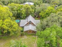 Aerial view of secluded home featuring a pool and surrounded by lush greenery and mature trees at 32125 Okaloosa Trl, Sorrento, FL 32776