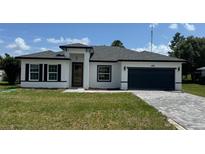 Charming single-Gathering home with a modern design, well-manicured lawn, and paved driveway at 482 Marion Oaks Mnr, Ocala, FL 34473