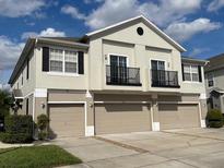 Inviting home featuring a three-car garage, neutral tones, and charming balcony at 6416 S Goldenrod Rd # 8A, Orlando, FL 32822