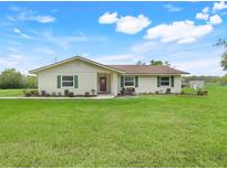 Charming single-story home features green shutters, landscaped yard and a well-maintained lawn at 6720 Midland Drive, St Cloud, FL 34771