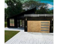 Sleek, modern exterior with unique wood garage door and minimalist landscaping at Tbd Sw 177Th St, Ocala, FL 34473