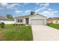 Charming single-story home featuring a well-maintained lawn, two car garage and neutral color palette at 1010 Morvan Ln, Kissimmee, FL 34759