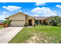 Charming single-story home with attached garage and well-maintained lawn at 1165 Indian Ridge E Trl, Kissimmee, FL 34747
