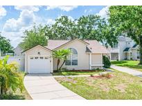 Charming single-story home featuring a well-manicured lawn, a one-car garage, and welcoming curb appeal at 126 Spanish Moss Ct, Orlando, FL 32828