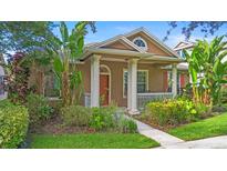 Charming home with inviting front porch, mature landscaping, and attractive architectural details at 12868 Holdenbury Ln, Windermere, FL 34786