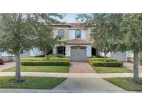 Charming townhome featuring a well-manicured front yard and a lovely tile roof at 14088 Tarvin St, Orlando, FL 32832