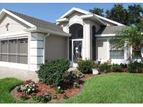 Charming home featuring a well-manicured lawn and beautiful landscaping in the front yard at 1430 Challenger Ave, Davenport, FL 33897