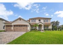 Charming two-story home featuring a three-car garage and lush landscaping at 2507 Water Valley Dr, St Cloud, FL 34771