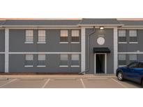 Modern apartment building with gray exterior, white trim and neatly marked parking spaces at 2791 L B Mcleod Rd # C, Orlando, FL 32805