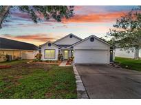Charming single-story home with a well-manicured lawn and colorful landscaping at 280 Bay St, Apopka, FL 32712