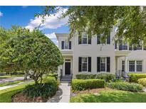 Charming two-story townhome with lush landscaping and a welcoming entrance at 3798 Lower Union Rd, Orlando, FL 32814