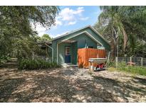 Charming home with a blue exterior, surrounded by lush greenery and foliage at 42108 Pine Valley Dr, Paisley, FL 32767