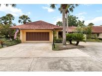 Charming single Gathering home with a red tile roof and beautifully landscaped front yard at 5057 Maui Cir # 15, Orlando, FL 32808