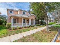 Charming two-story home with a welcoming front porch and manicured landscaping at 7184 Maleberry Run, Winter Garden, FL 34787