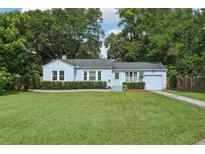Charming single-story home with a well-manicured lawn and mature trees provides inviting curb appeal at 826 Garden Plz, Orlando, FL 32803