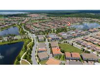 Stunning aerial view of a meticulously planned community with picturesque lakes and lush green spaces at 10072 Sunnifa Aly, Orlando, FL 32832