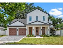 Stunning two-story home with a three-car garage, modern design, and lush landscaping at 1780 Mizell Ave., Winter Park, FL 32789