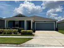 Charming single-story home with lush landscaping and a well-maintained front yard at 1950 Birnham Wood Bnd, Kissimmee, FL 34746