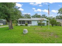 Charming single-story home with a well-manicured lawn and an American flag proudly displayed at 2538 Meadowview Ln, Deland, FL 32720