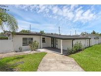 Charming single-story home with a well-maintained lawn and inviting front porch at 3430 Arbutus Ln, Winter Park, FL 32792