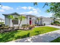 Charming single-story home with well-manicured landscaping and a bright red front door at 3711 Half Moon Dr, Orlando, FL 32812