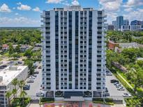 Tall white highrise condominium building with balconies and city views on a sunny day at 400 E Colonial Dr # 1501, Orlando, FL 32803