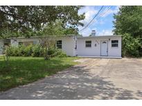 Inviting single-story home featuring a well-maintained lawn and a neutral color palette at 438 Romano Ave, Orlando, FL 32807