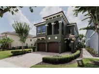 Beautiful two-story home with a red brick driveway, two-car garage, and well-maintained landscaping at 1156 Castle Pines Ct, Reunion, FL 34747