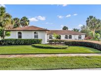 Beautiful single-story home with lush landscaping and a well-manicured lawn under a bright, sunny sky at 137 N Spring Lake Dr, Altamonte Springs, FL 32714