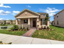Charming single-Gathering home with a welcoming front porch and manicured landscaping at 16242 Outlook Shore Aly, Winter Garden, FL 34787