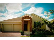Charming single-story home with a brick-accented entrance and two-car garage at 1889 Blissful Dr, Kissimmee, FL 34744